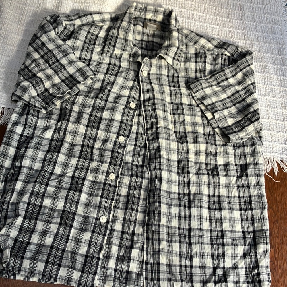 Mens short sleeved black/white plaid. Lg. Collared, button up shirt. Rayon/poly.